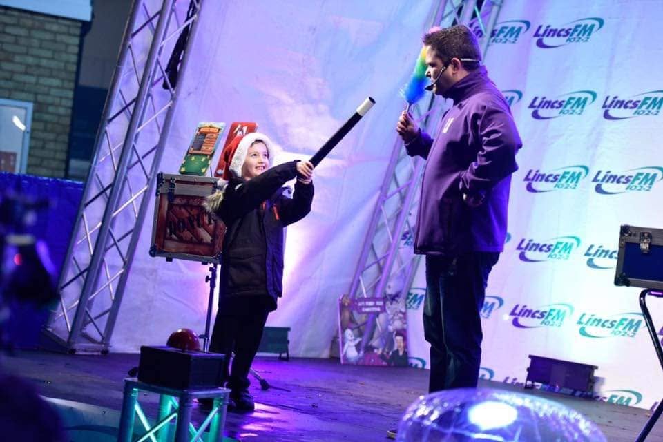A young volunteer helping JJ during a show