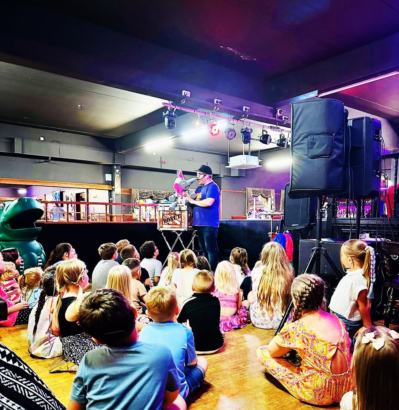 Children watching JJ perform during a Magic & Mini Disco party
